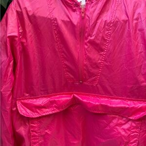 Vibrant vintage red hooded windbreaker and gym bag